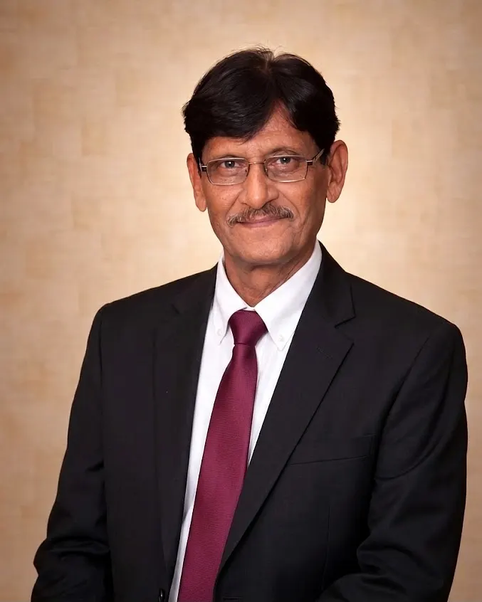 Munir Iqbal Siddiqui, founder of Hers Cottons, in a black suit and burgundy tie