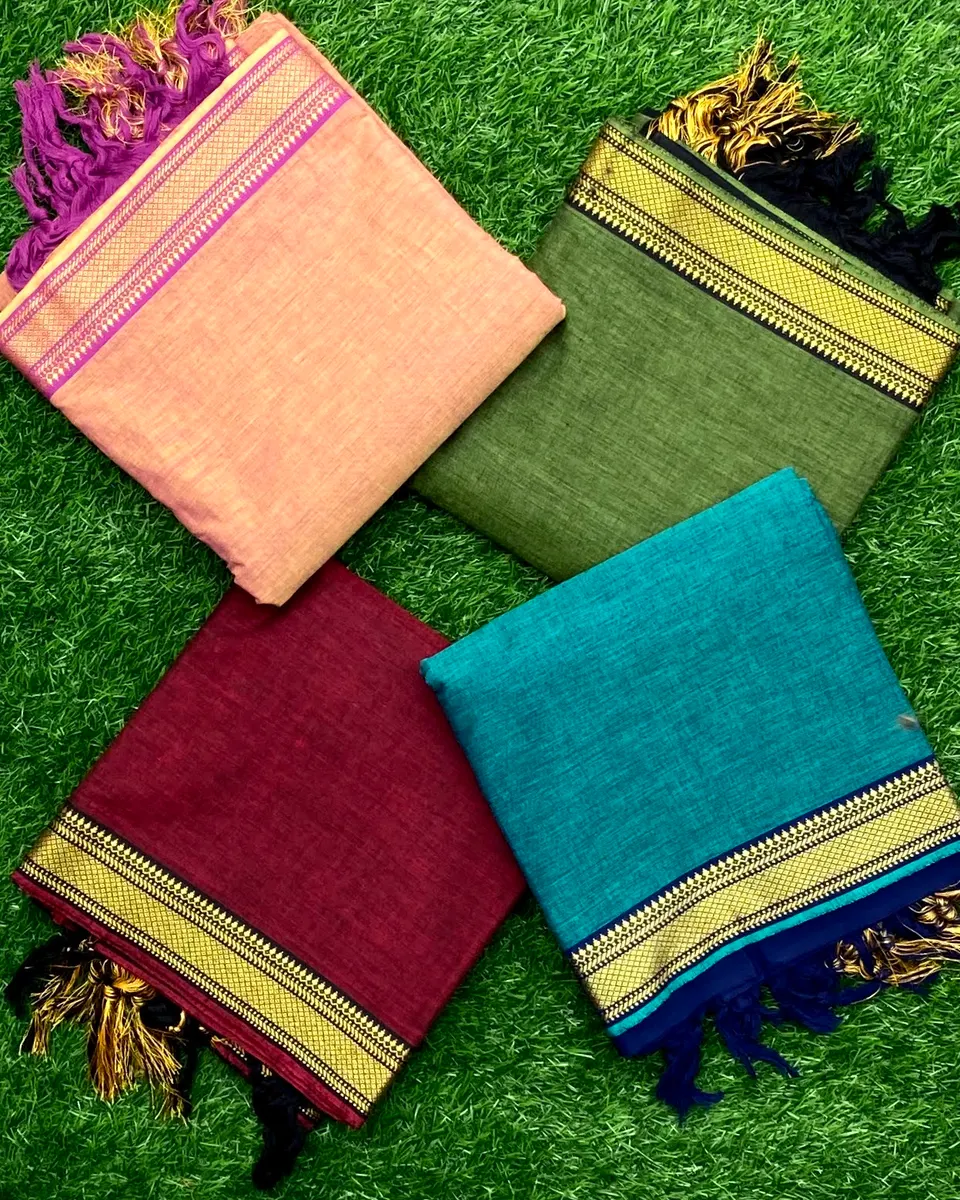 Plain handloom cotton folded in peach, olive, maroon and teal, each with a gold woven border