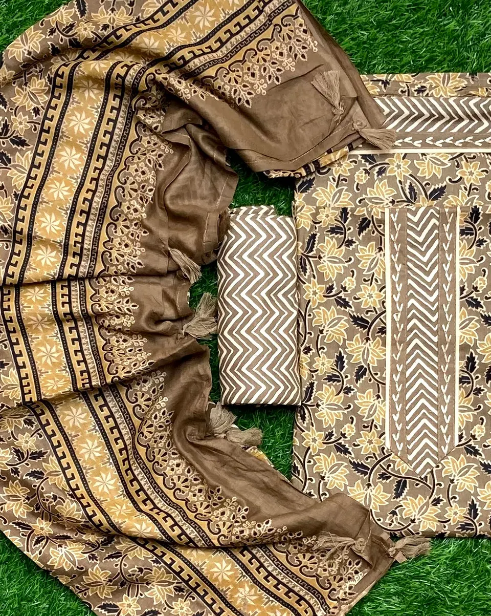 Bronze and cream suit pieces with a broad ornamental border and geometric print